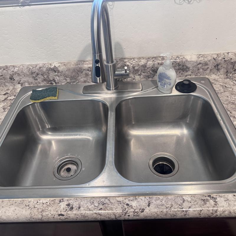Kohler double-bowl kitchen sink with faucet installed Kohler double-bowl kitchen sink with faucet installed