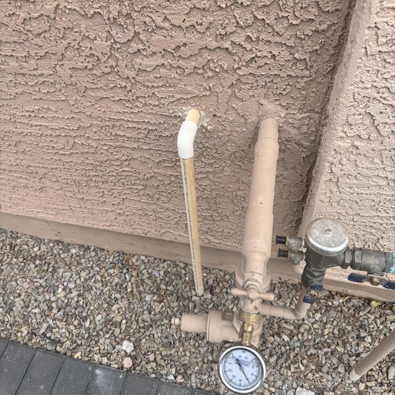 Water pressure regulator and meter on exterior plumbing Water pressure regulator and meter on exterior plumbing