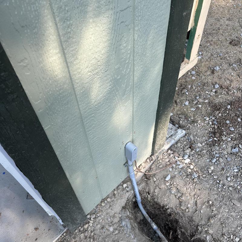Outdoor electrical conduit and GFCI installation near wall