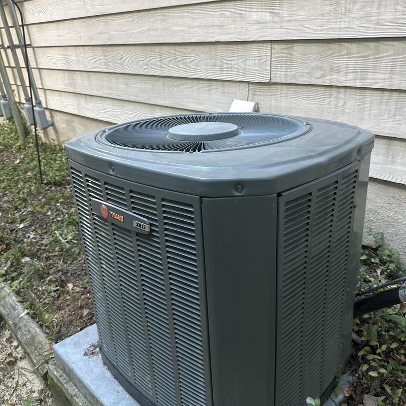 Outdoor Trane XR12 air conditioning unit maintenance