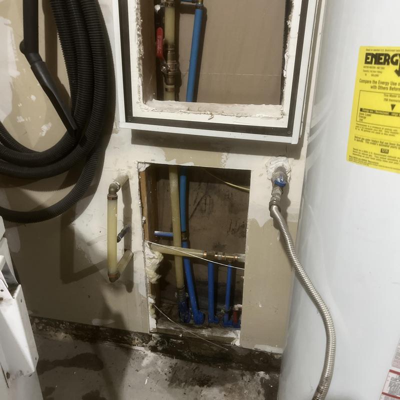 Water service pipes exposed in drywall leak inspection Water service pipes exposed in drywall leak inspection