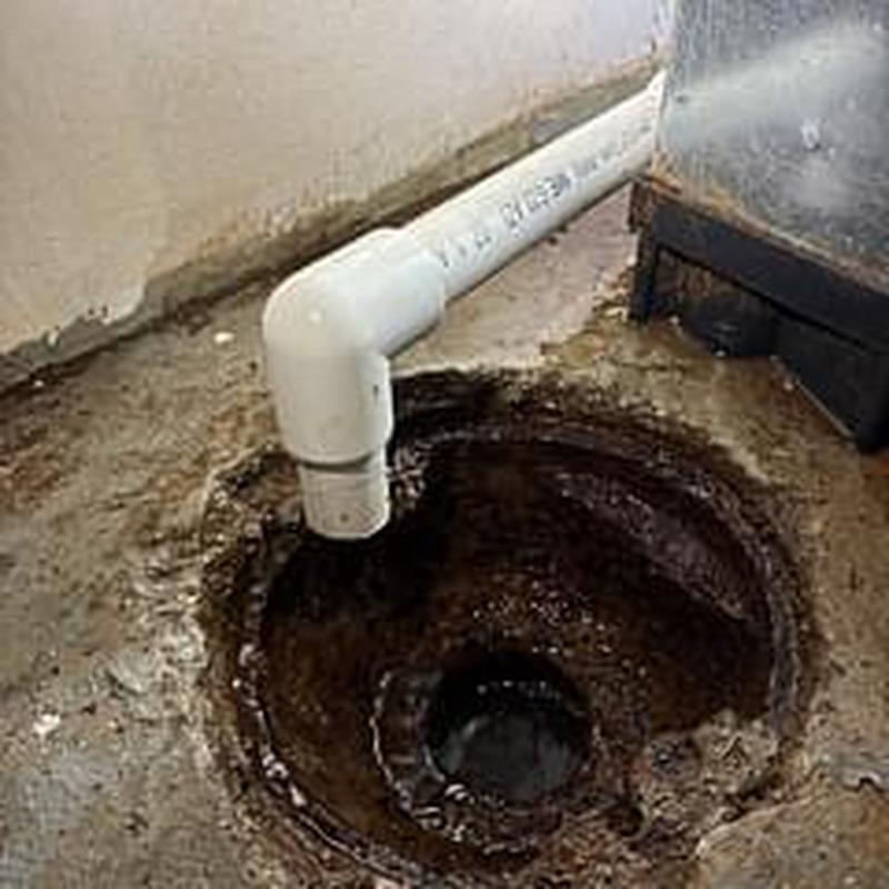 Cast iron floor drain with PVC pipe connection