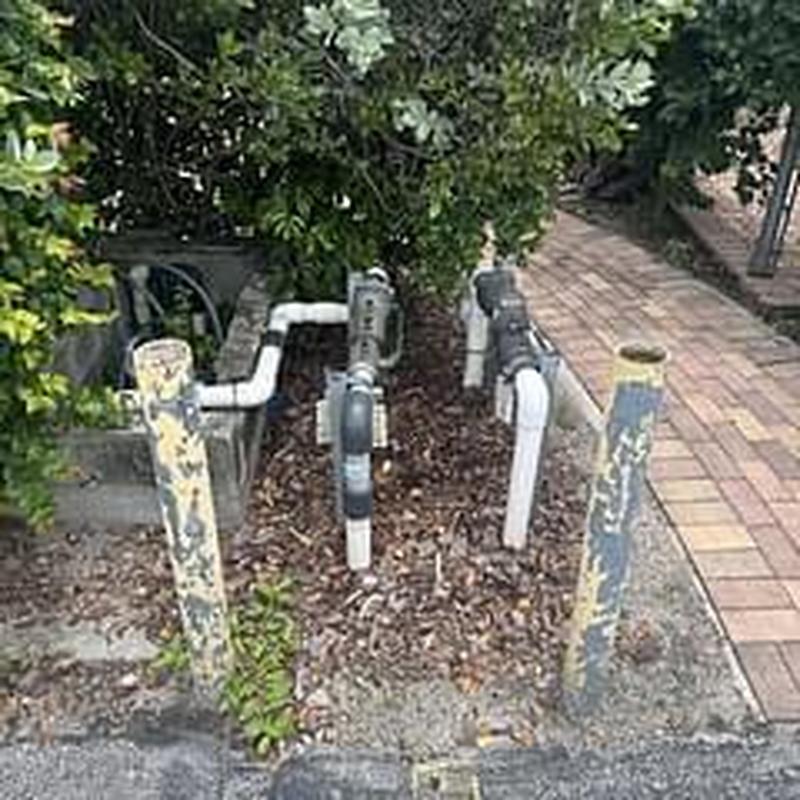 Backflow prevention valves with piping in ground area