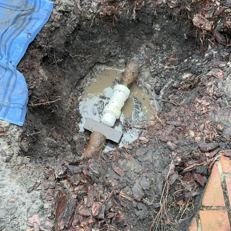 Galvanized pipe with PVC cap and brick wedge in soil Galvanized pipe with PVC cap and brick wedge in soil