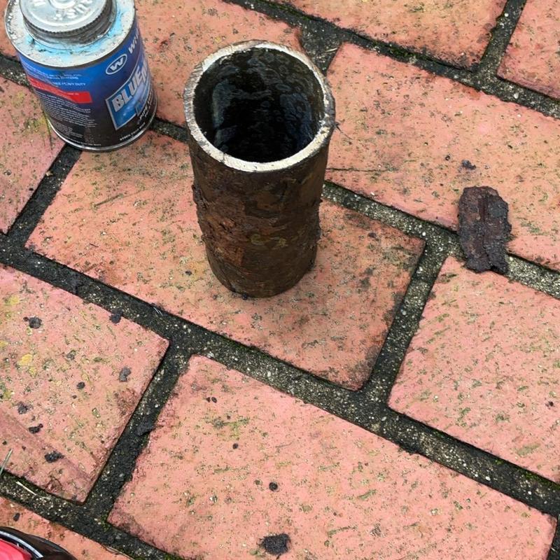 Galvanized pipe section removed from brick patio Galvanized pipe section removed from brick patio