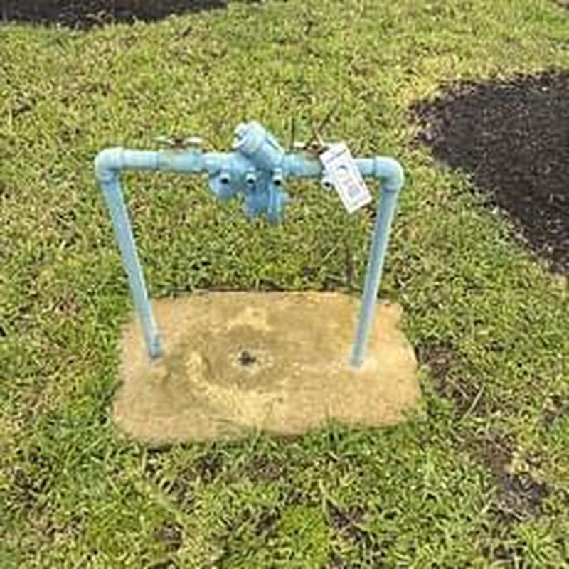 Backflow prevention device with test certification tag