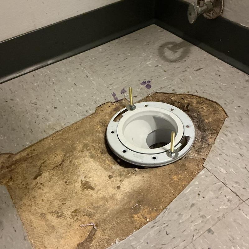 Toilet flange installed flush with floor on vinyl tiles Toilet flange installed flush with floor on vinyl tiles