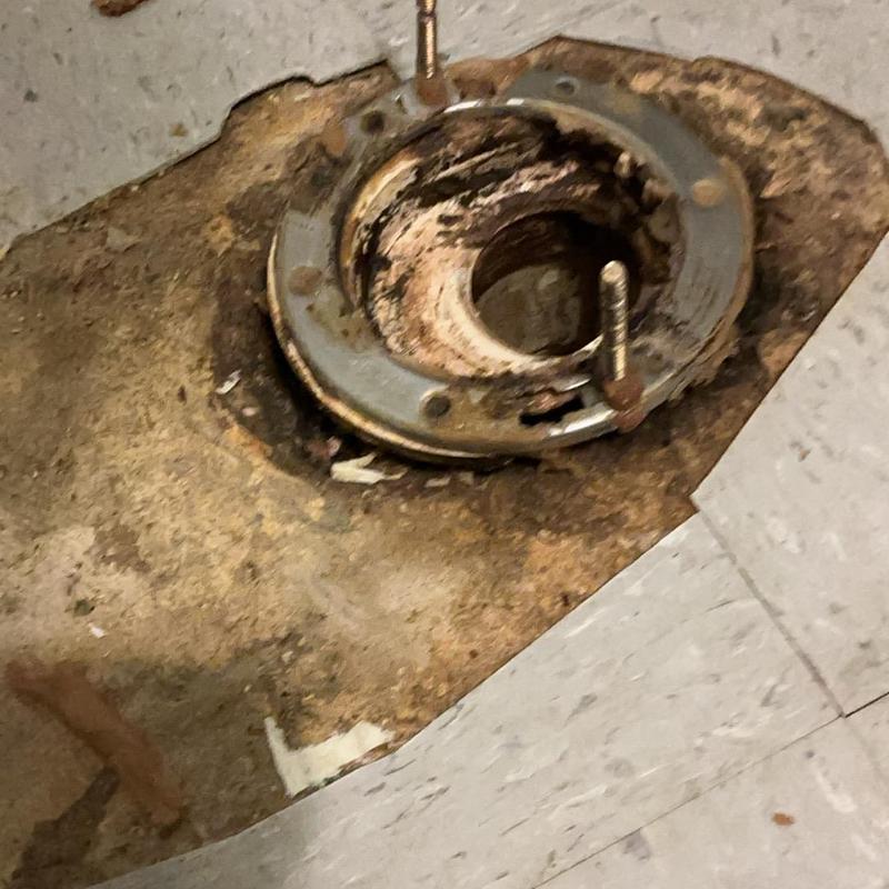 Toilet flange with rusted flooring underneath Toilet flange with rusted flooring underneath
