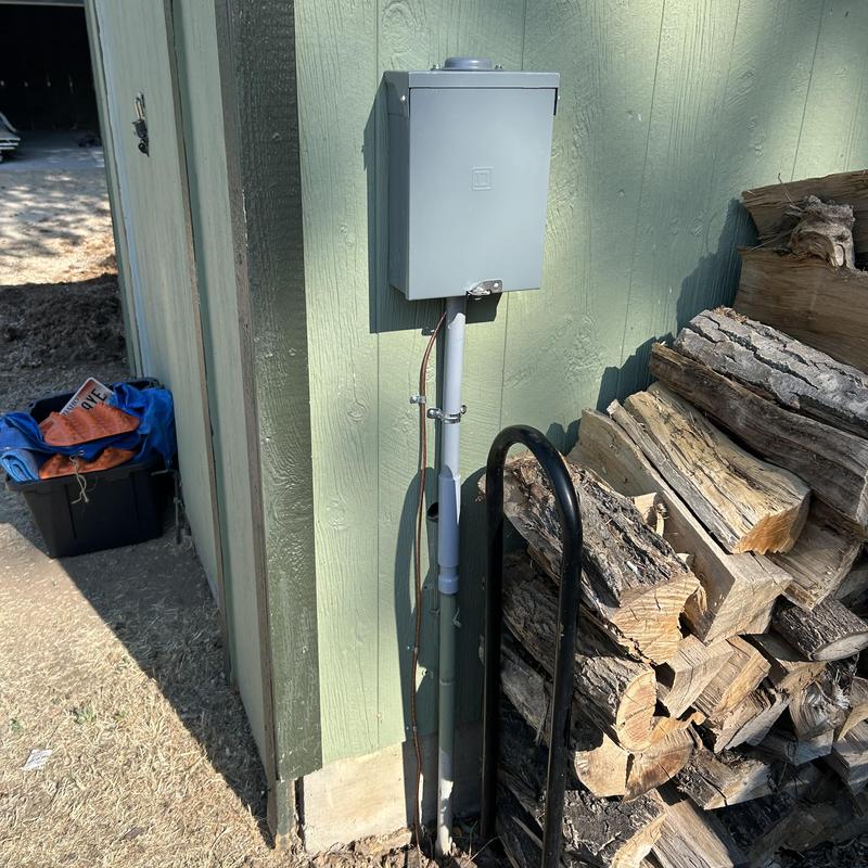 Electrical meter base and conduit on exterior wall