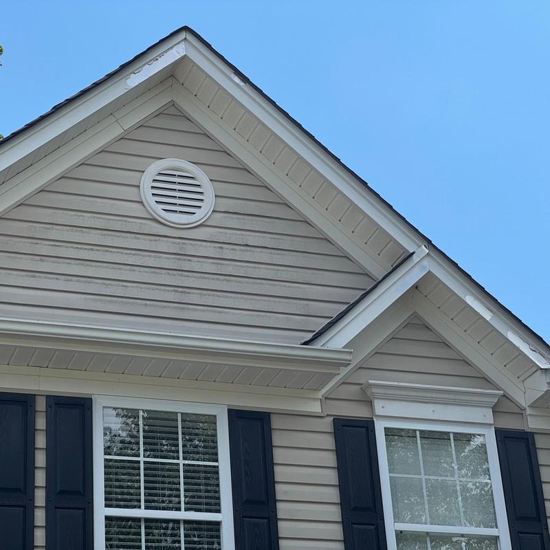 Fascia and soffit on house roof peak under clear sky