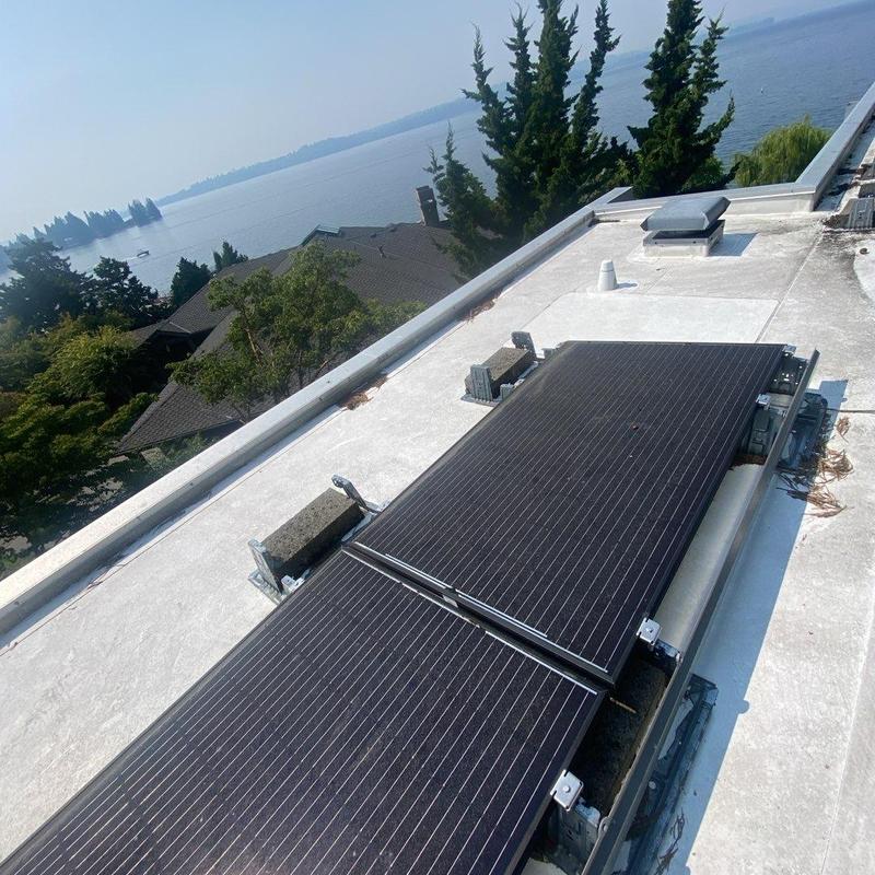 Solar panels on flat roof near water view