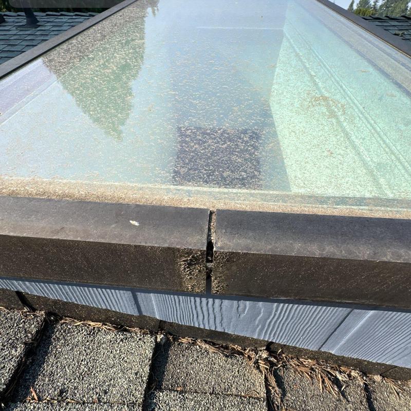 Skylight frame with visible crack on roof surface