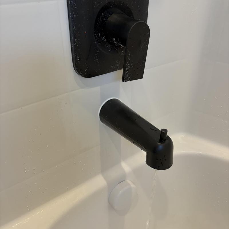 Matte black tub spout and faucet valve with water flow Matte black tub spout and faucet valve with water flow