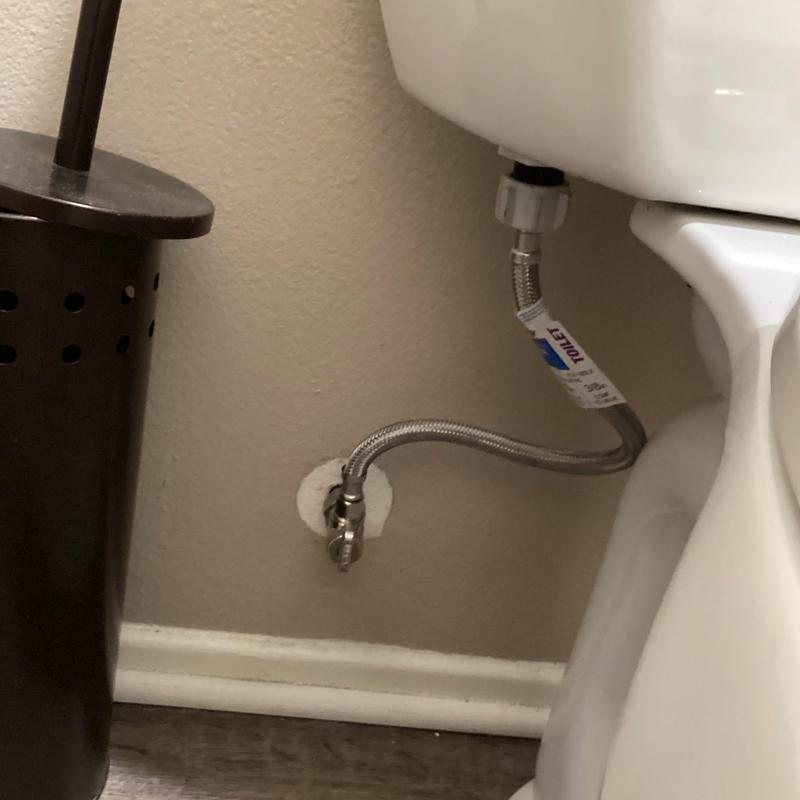 Angle stop valve with braided water line on toilet