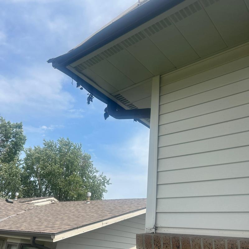 Aluminum gutter system on white residential home Aluminum gutter system on white residential home