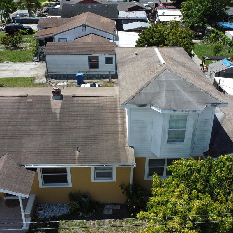 Asphalt shingle roof with discoloration and aging