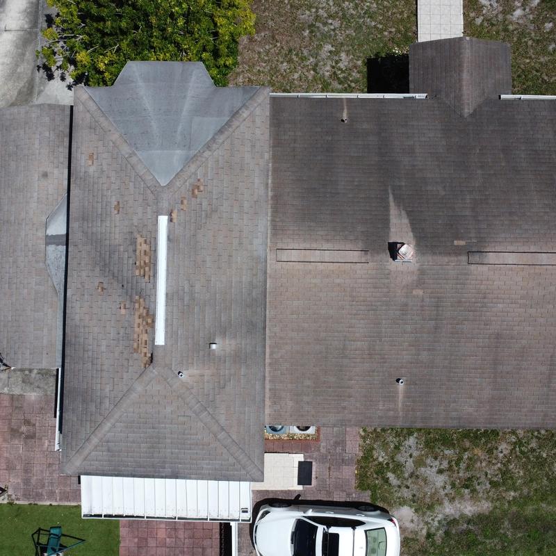 Shingle roof with damaged patches before replacement
