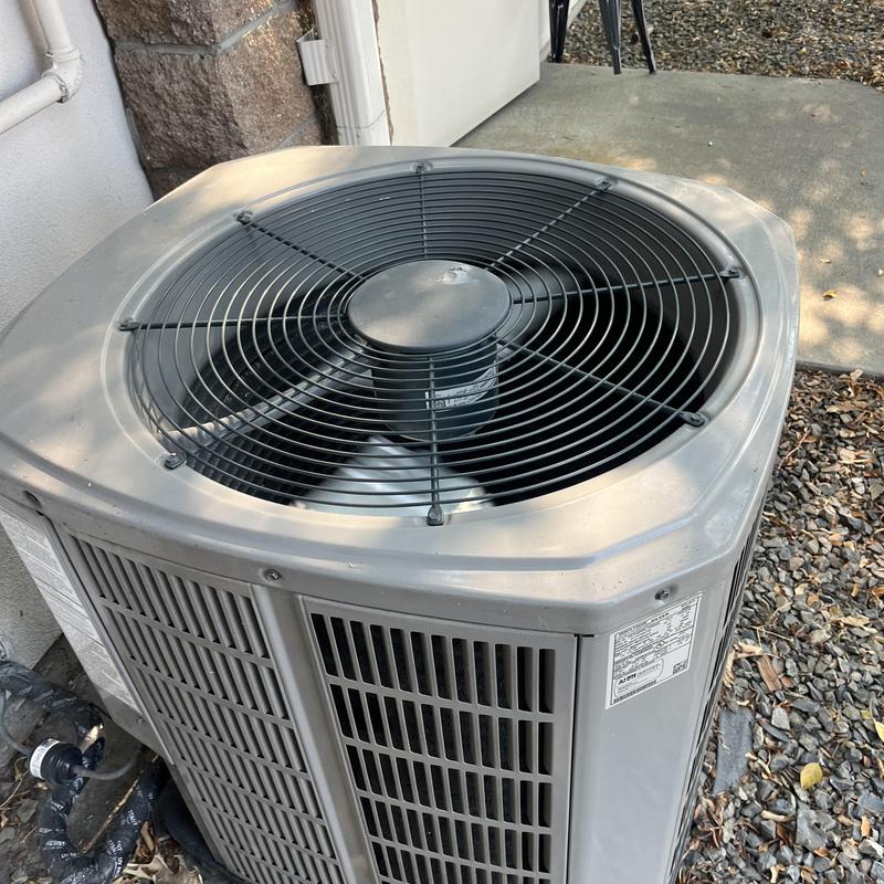 Outdoor AC condenser unit on residential property Outdoor AC condenser unit on residential property