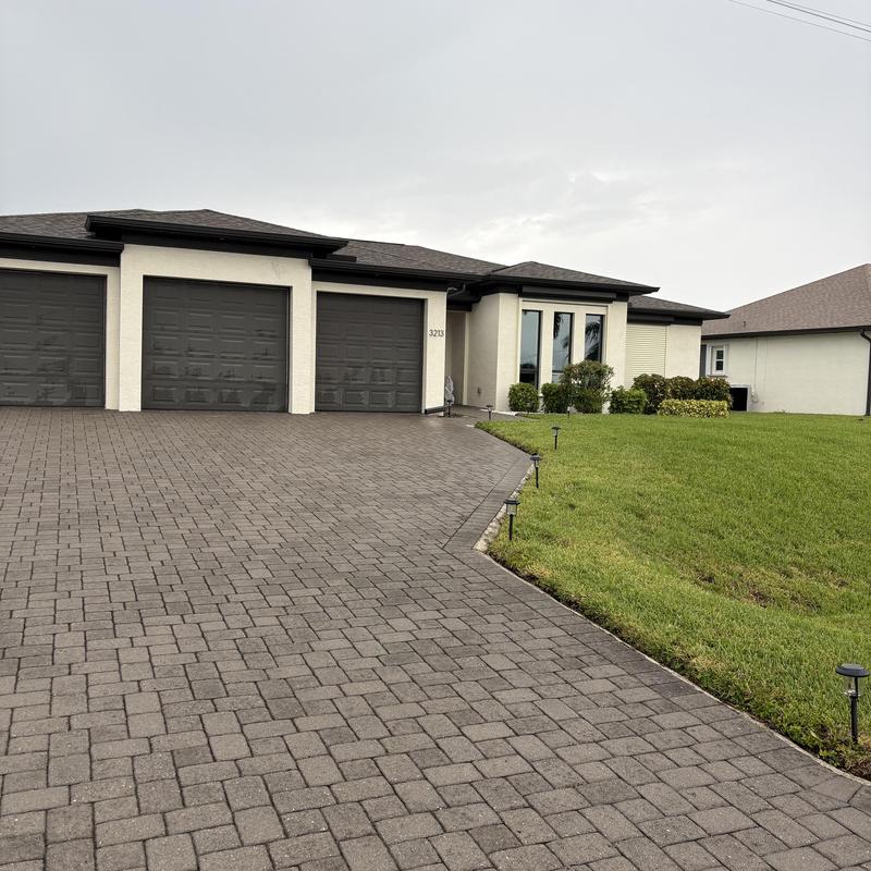 Driveway paver installation and landscaping in residential yard