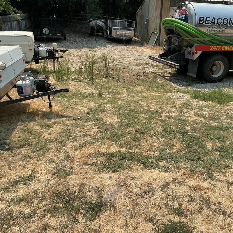 Septic tank pumping truck and equipment on dry grass Septic tank pumping truck and equipment on dry grass