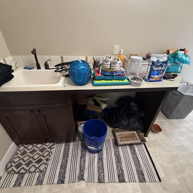Bathroom sink and faucet with countertop clutter