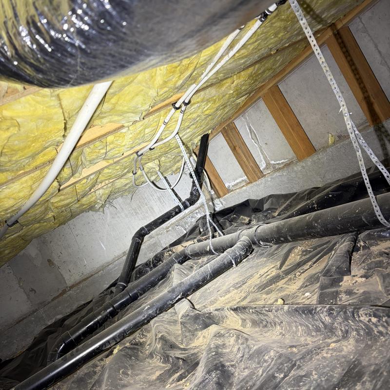 Bathroom drain and vent pipe installation in crawlspace