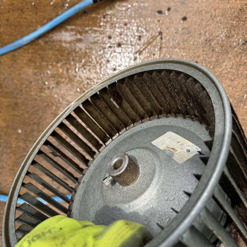 Heat pump blower wheel on workshop floor