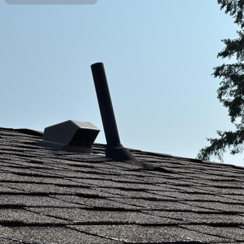 Roof vent and pipe flashing on shingle roof