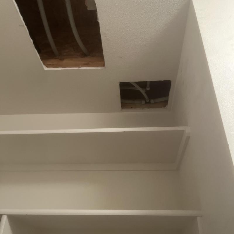 Water piping with access holes in ceiling drywall Water piping with access holes in ceiling drywall
