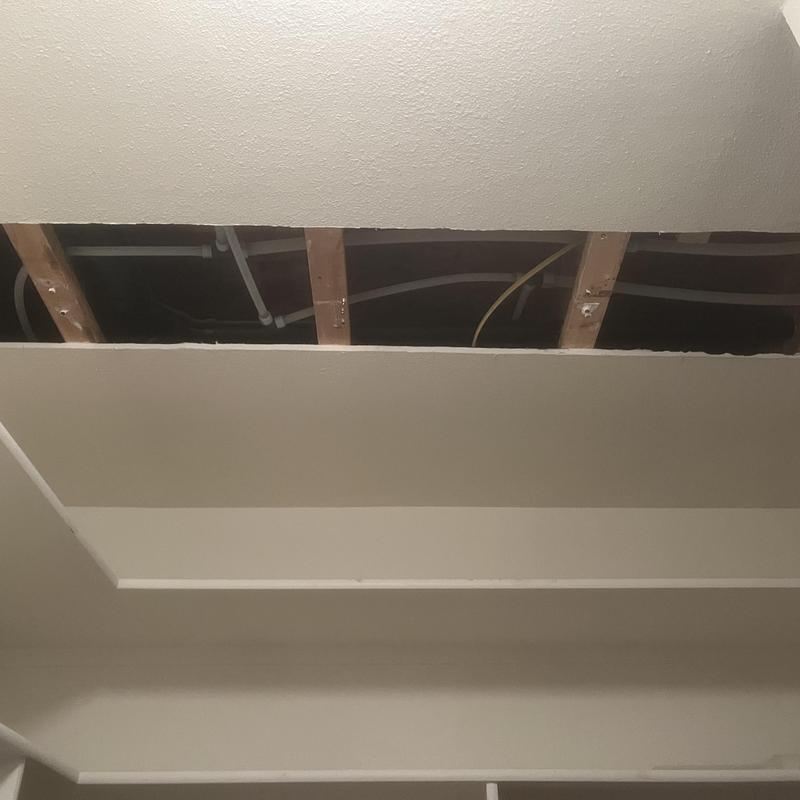 Water piping and valves in ceiling with drywall removed Water piping and valves in ceiling with drywall removed