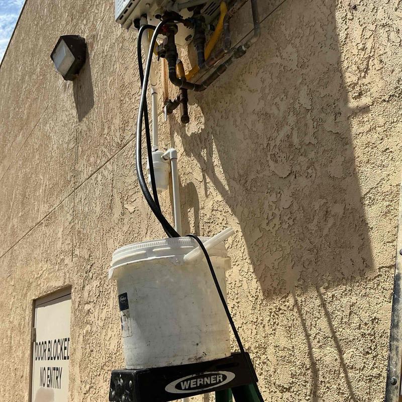 Tankless water heater flushing setup with bucket