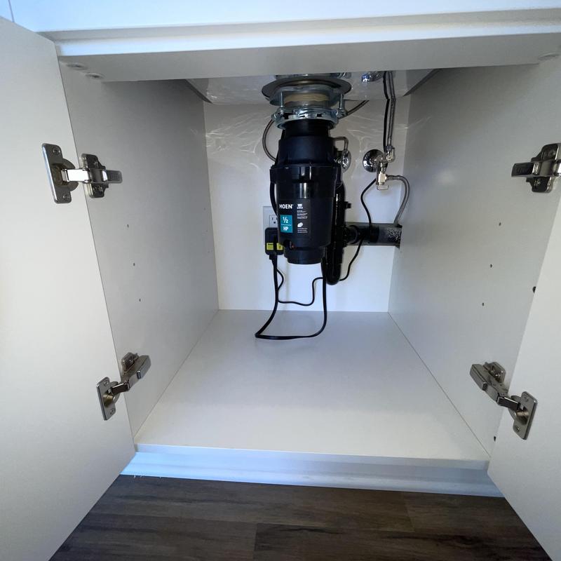 Garbage disposal unit installed under kitchen sink