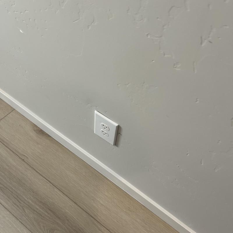Electrical wall outlet installation on textured wall