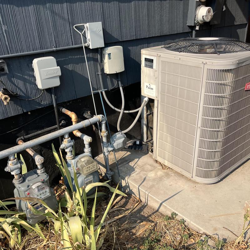 AC condenser and drain piping at home exterior AC condenser and drain piping at home exterior