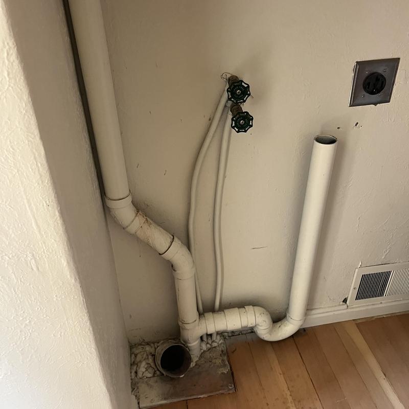 PVC drain piping and water shutoff valves in laundry area PVC drain piping and water shutoff valves in laundry area