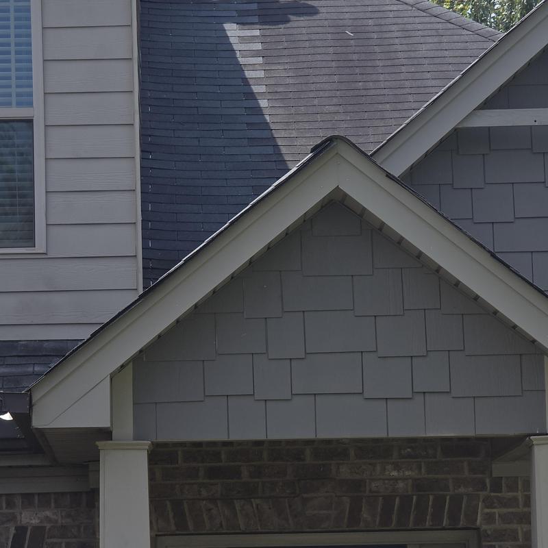 Step flashing and shingles on gray roof section