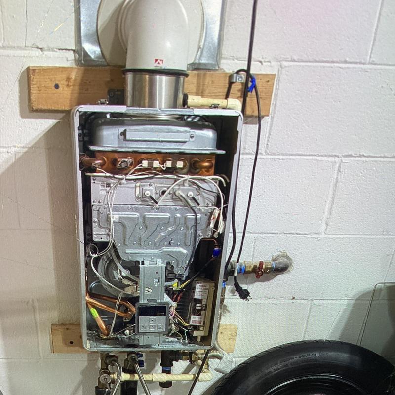 Tankless Rinnai water heater maintenance in garage