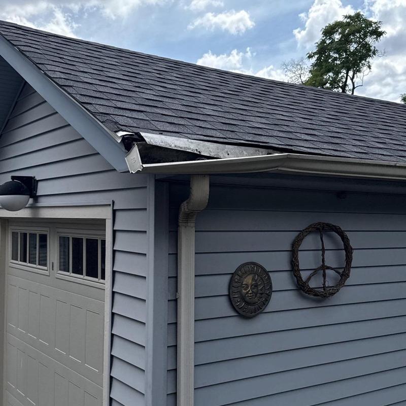 Asphalt shingle roof and aluminum gutter damage after storm Asphalt shingle roof and aluminum gutter damage after storm
