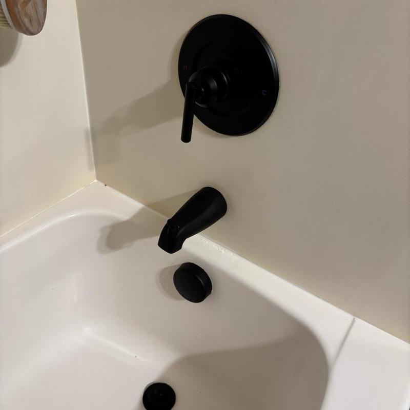 Bathtub tub trim with black faucet and drain trim