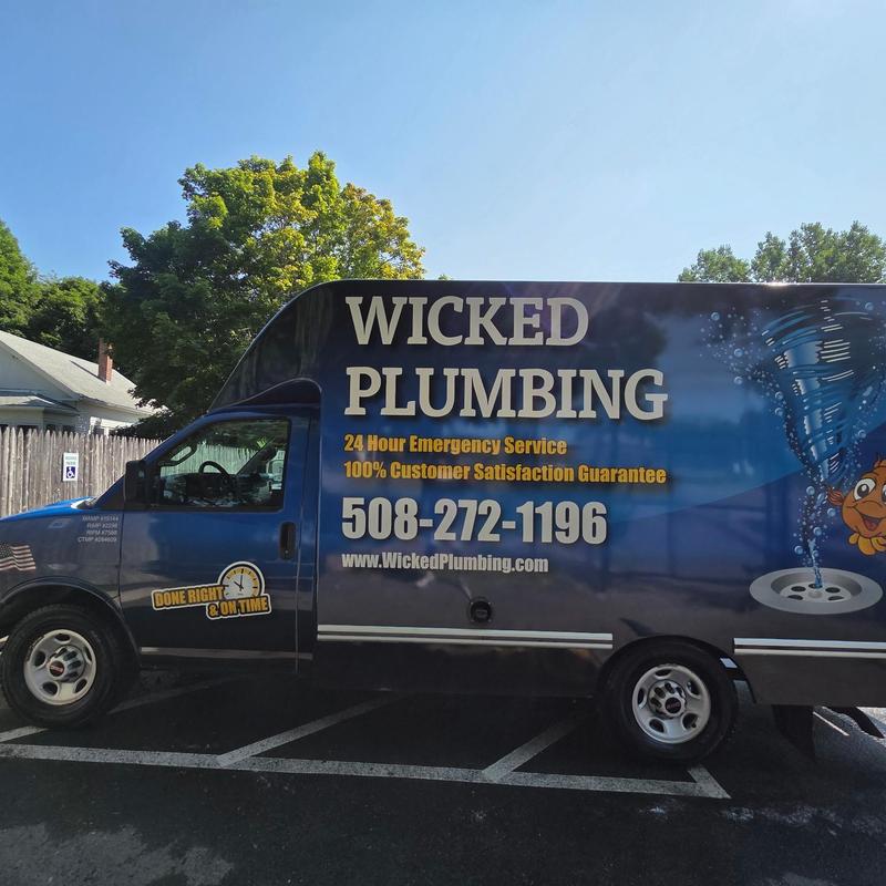 Plumbing service van with company branding parked Plumbing service van with company branding parked