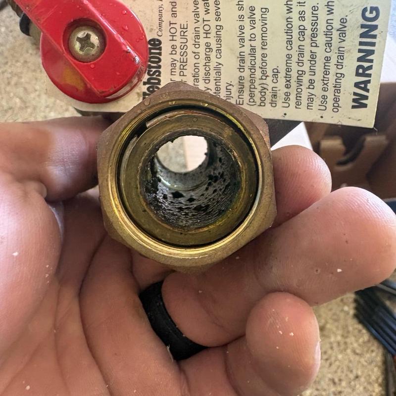 Tankless water heater drain valve showing corrosion inside Tankless water heater drain valve showing corrosion inside