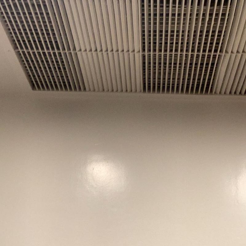 Ceiling air vent grille with HVAC system visible above