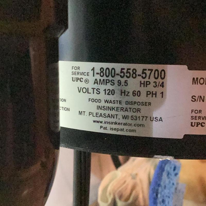 Garbage disposal label showing model and specs