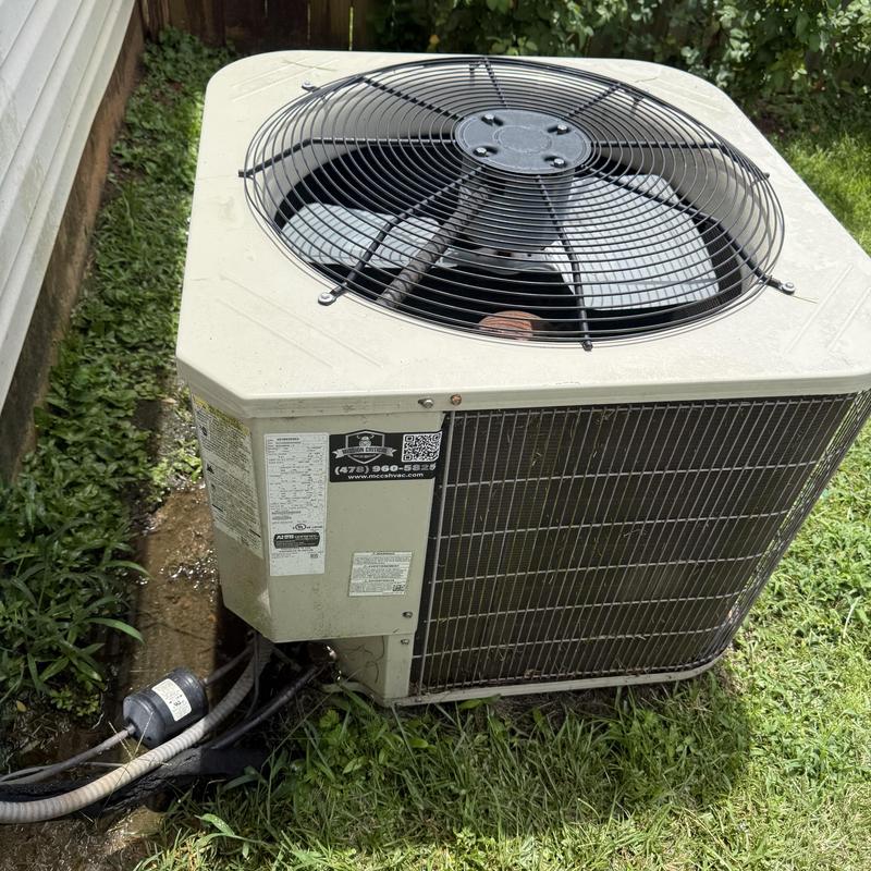 Outdoor HVAC condenser unit with fan and wiring Outdoor HVAC condenser unit with fan and wiring