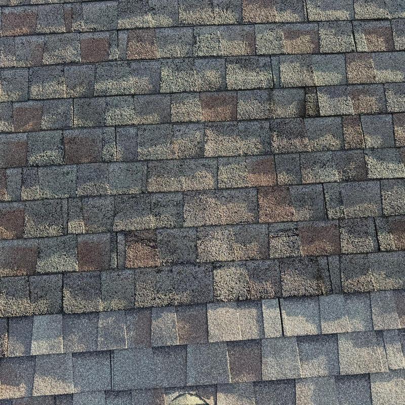 Asphalt shingle roof with visible hail damage and wear