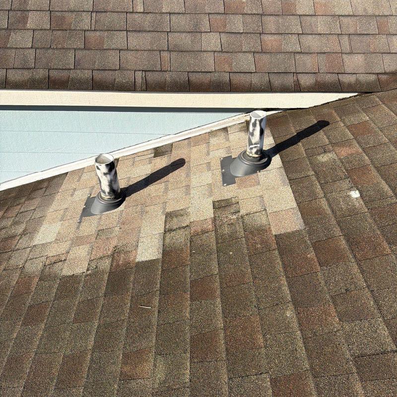 Roof vent flashing on shingle roofing with discoloration