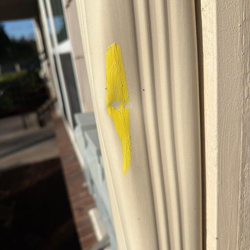 Exterior door frame with yellow paint damage mark