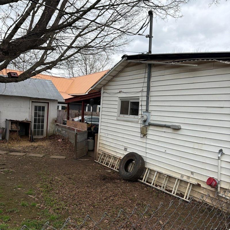 Roof edge with damaged shingles and flashing repairs needed