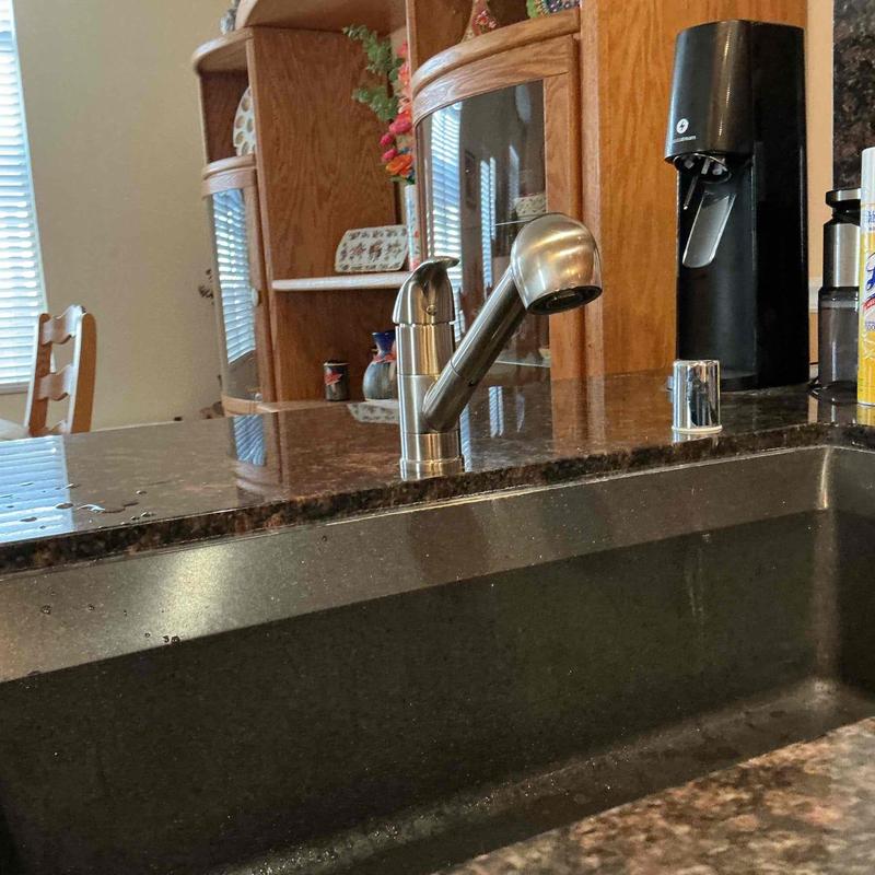 Kitchen faucet installed on granite countertop