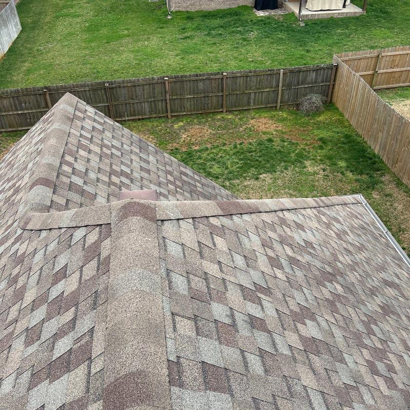 Asphalt shingle roof ridge and hip with hail damage inspection